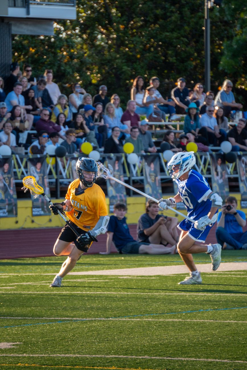 high school lacrosse match with enthusiastic crowd